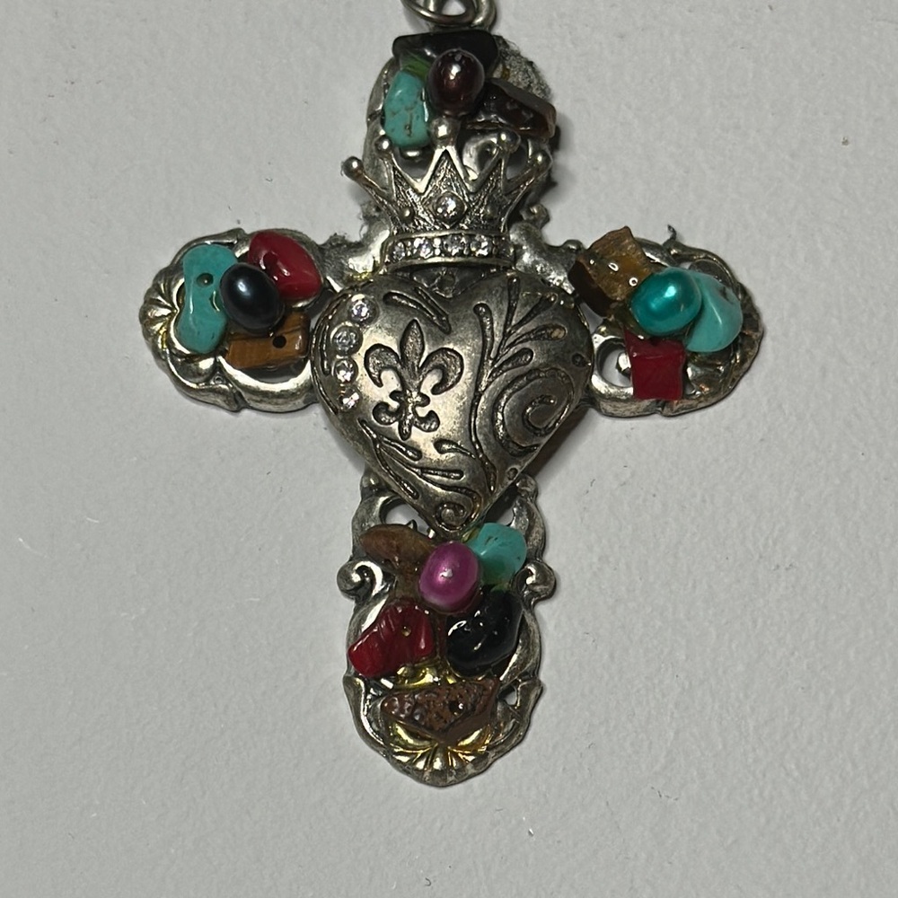 Unmarked, non-magnetic silver toed cross with stones pendant